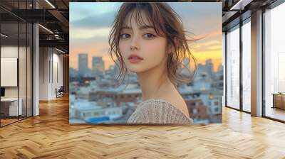 Model standing on a city rooftop, wearing a soft summer knit, the skyline glowing in the evening light, her knit gently flowing in the breeze, Wall mural