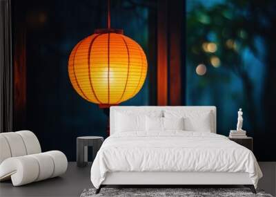 A glowing orange lantern hanging in a dark room, casting warm light and shadows around. Wall mural