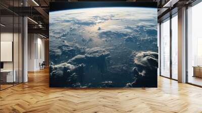 A view of Earth continents and oceans as seen from the International Space Station, with cloud formations covering parts of the land Wall mural