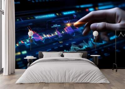 A hand touches a digital screen displaying a financial graph. Wall mural