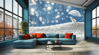 A small white rabbit figurine with a lace umbrella sits on a snowy hill in front of a blue bokeh background with white sparkles. Wall mural