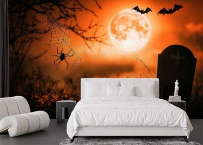 A spider sits on a web in front of a spooky, full moon and a tombstone. Wall mural