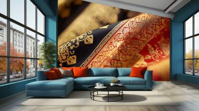 Close-up of red and black fabric with intricate gold designs. Wall mural