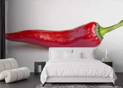 Single red chili pepper with a green stem on a white background. Wall mural