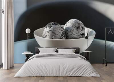 Two scoops of black sesame ice cream in a white bowl on a glass table. Wall mural