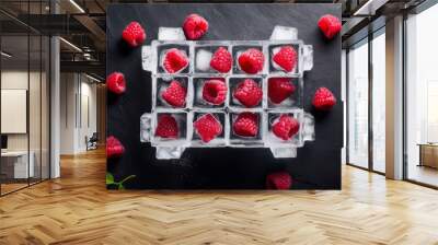 Fresh juicy raspberry and ice cubes on dark stone background. Flat lay, top view. Citrus fruits cut.Summer freshness, poster design.  Wall mural