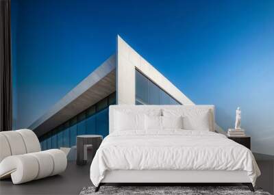 Sharp angles of a minimalist architectural building against a clear sky background, modern, geometric, design Wall mural