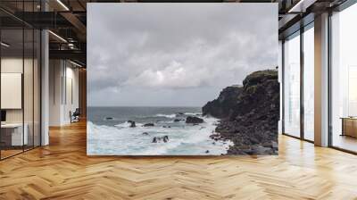 Sea coming in waves on the shore in the Azores of Portugal. Wall mural