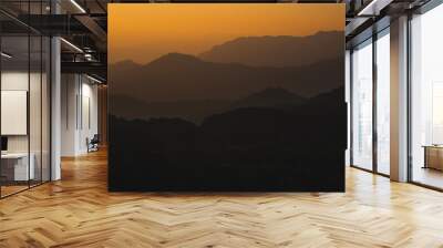 nature traveling with orange sky and layer of mountain with sunrise background Wall mural