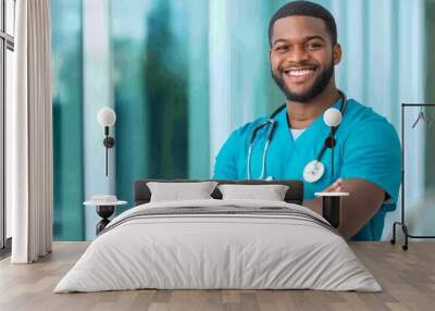 A smiling male nurse or doctor wearing a blue scrub top stands in a hospital corridor with his arms crossed, conveying confidence and professionalism. He is wearing a stethoscope around his neck, and  Wall mural