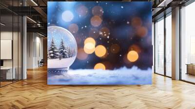 Snow globe with christmas tree on snow and bokeh background Wall mural