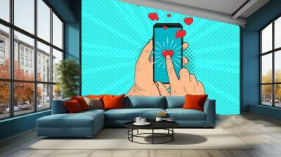 A hand with a smartphone send hearts. Pop Art vintage vector illustration Wall mural