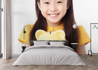 Asian smiling kid girl with a piggy bank in his hands, white background. AI generative Wall mural