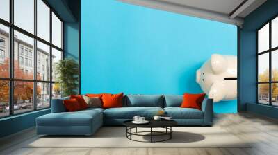 A piggy bank saving and investment theme on a blue paper background Wall mural