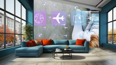 Airplane travel theme with man using a laptop in a modern gray chair Wall mural