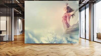 Beautiful woman jumping on a giant flower Wall mural