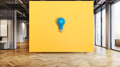 Blue painted light bulb on a vibrant background Wall mural