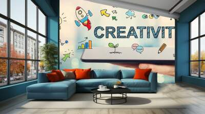 Creativity concept with man holding a tablet Wall mural