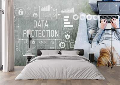 Data protection with man using a laptop in a modern gray chair Wall mural