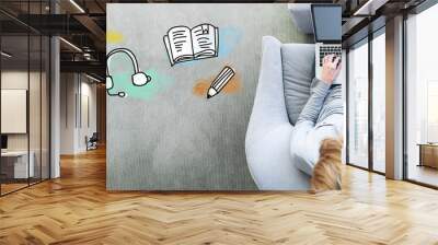 E-Learning with man using a laptop in a modern gray chair Wall mural