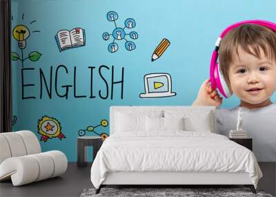 English with toddler boy with headphones on a blue background Wall mural