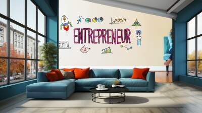 Entrepreneur text with young woman holding a tablet computer in a chair Wall mural