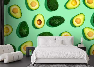 Fresh avocado pattern on a green background flat lay Wall mural