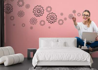 Gears with young woman using her laptop Wall mural