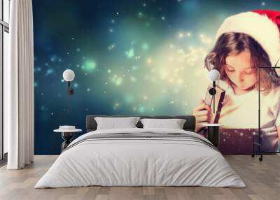 Girl with Santa Hat Opening Gift Box Wall mural