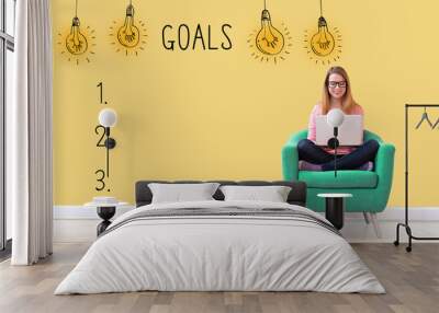 Goal list with young woman using her laptop in a chair Wall mural