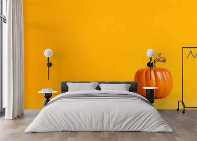 Halloween pumpkin decorations on a yellow-orange background Wall mural