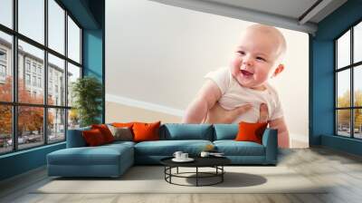 Happy infant baby girl being held up in the air Wall mural