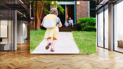 happy toddler girl arriving home from school with a backpack Wall mural