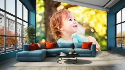 happy toddler girl smiling outside Wall mural