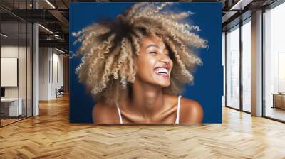 Happy young african american woman on a solid background Wall mural