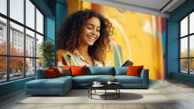 Happy young Hispanic woman woman using her phone Wall mural