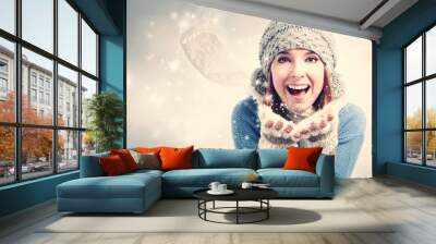 Happy young woman blowing snow Wall mural