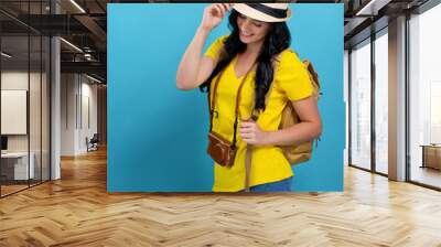 Happy young woman hiking on a blue background Wall mural