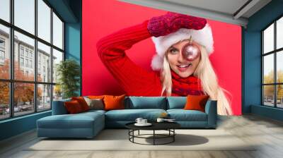 Happy young woman holding a Christmas bauble Wall mural