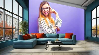 Happy young woman on a solid background Wall mural