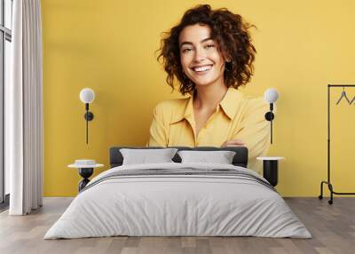 Happy young woman on a yellow background Wall mural