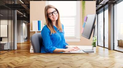 happy young woman working in her home office Wall mural