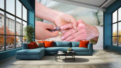 helping senior woman cutting her fingernails Wall mural