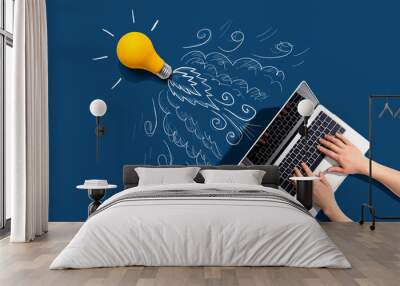 Idea light bulb flying to the sky like a rocket from a laptop computer - Flat lay Wall mural