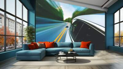 Luxury vehicle driving down the road with motion blur Wall mural