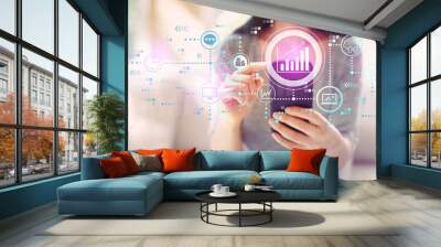 Marketing concept with woman using her smartphone in a living room Wall mural