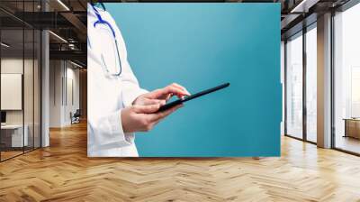 Medical doctor with digital tablet on a blue background Wall mural