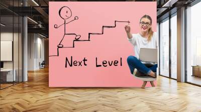 Next level concept with young woman using her laptop Wall mural