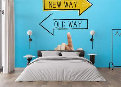 Old way or new way with hand on a blue background Wall mural