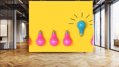 One outstanding idea concept with light bulbs on a yellow background Wall mural